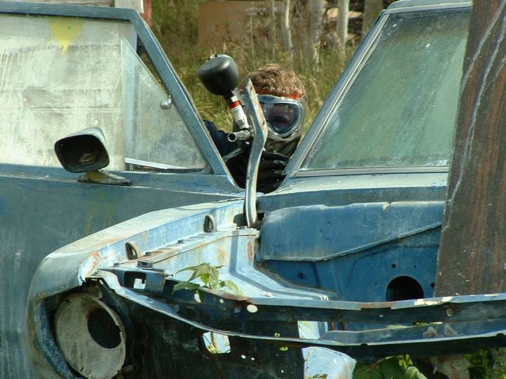 An old car body makes a classic woodsball bunker